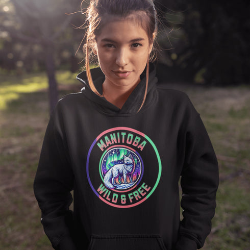 Unleash your wild side with our Manitoba – Wild & Free hoodie, featuring an enchanting graphic of an arctic fox beneath the dazzling northern lights.